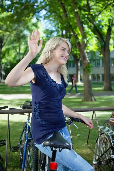 College student waving hand at someone — Stock Photo, Image