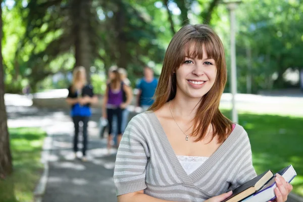 Portrait of smiling young college girl — Stock Photo, Image