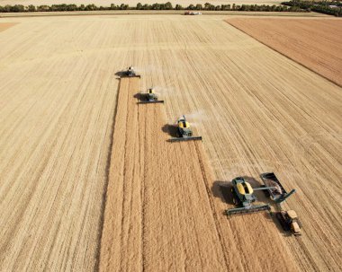 Aerial View of Harvesters in Formation clipart