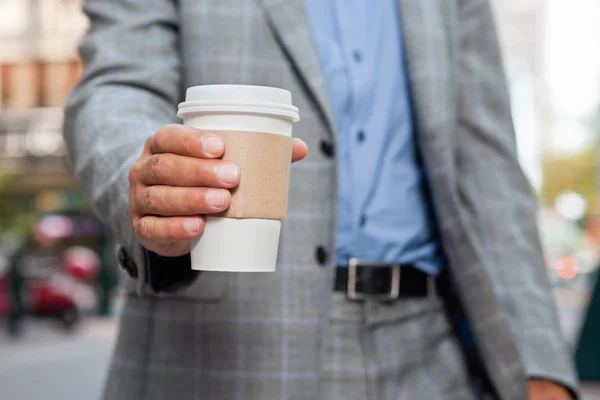 Businessman holding disposable cup — Stock Photo, Image