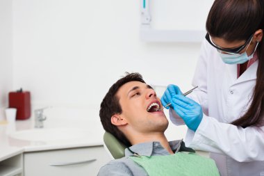 Dentist examining patient clipart