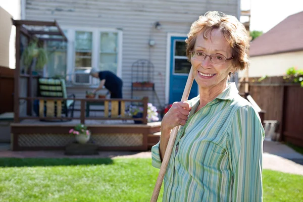 Senior Woman holding gardening tool — Stock Photo, Image