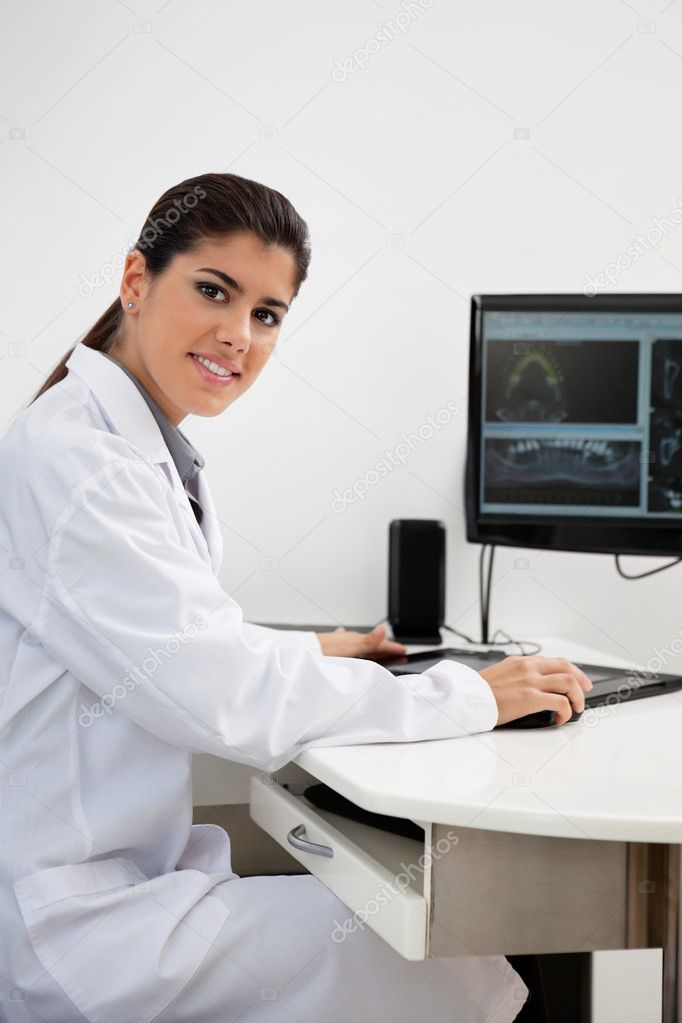 Female dentist working on computer