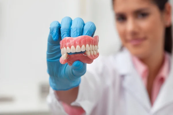 Жіночий стоматолог тримає зубну форму — стокове фото