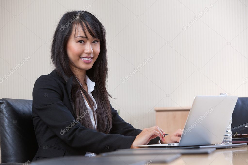Young business woman working on laptop