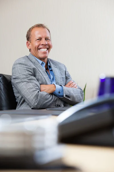Portrait of executive sitting with hands folded Royalty Free Stock Images