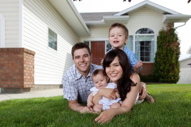 Happy Family of Four Lying Down on Grass clipart