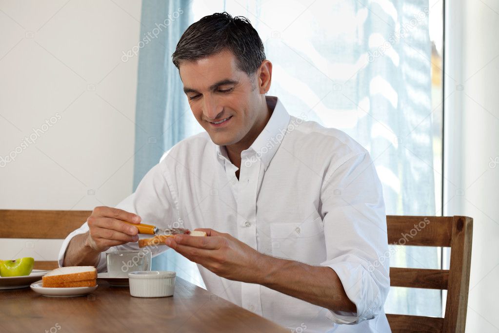 Smiling Man Having Breakfast