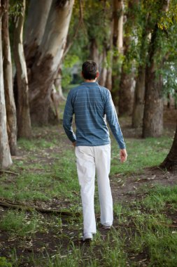 Man Walking Alone in Woods clipart