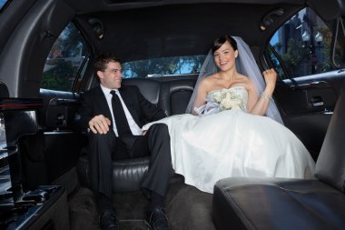 Happy couple in limousine clipart