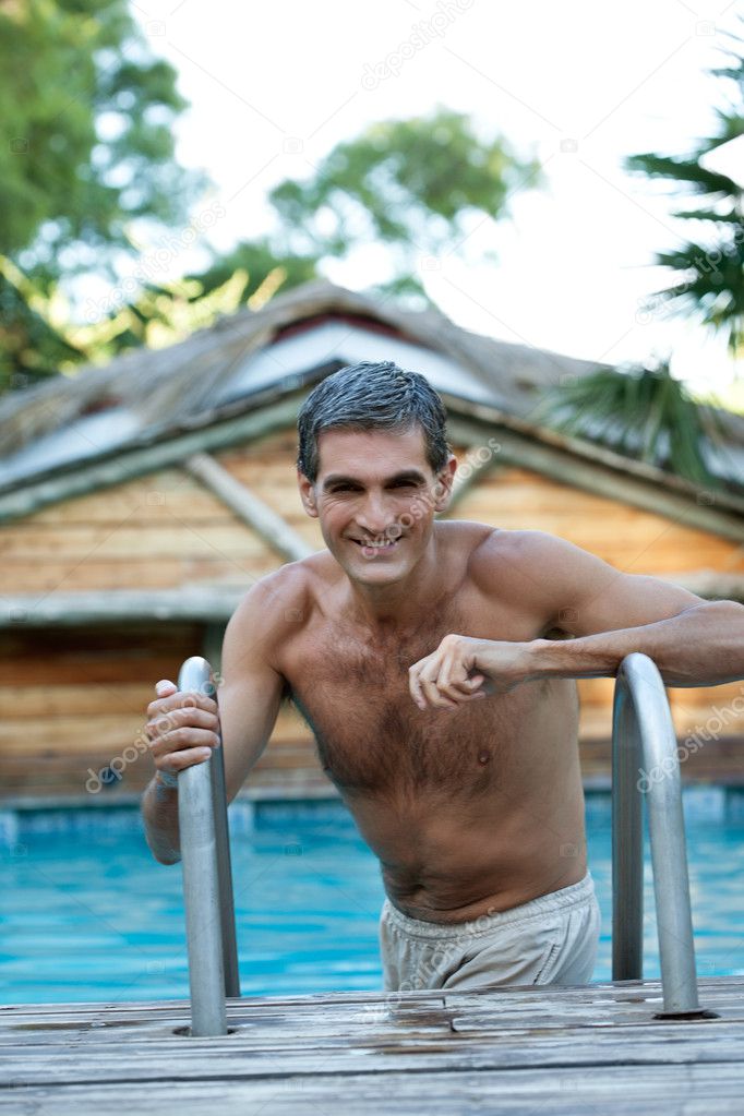 Smiling Middle Aged Man Standing in Pool