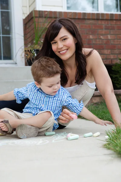 Mother and Son Playing with Sidewalk Chalk Royalty Free Stock Photos