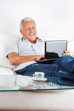 Relaxed Senior Man Working on Laptop clipart