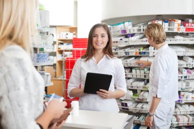 Female Pharmacist Holding Tablet PC clipart