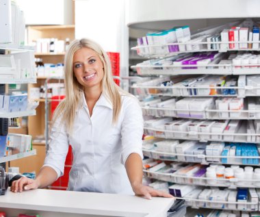Female Pharmacist Standing at Checkout Counter