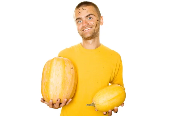 Young man holding a yellow squash — Stock Photo, Image