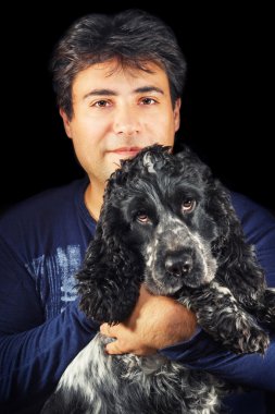 Man holding a cute black and white english cocker spaniel clipart