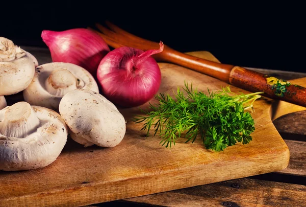 stock image Mushrooms, onions and fresh herbs on a cutting board