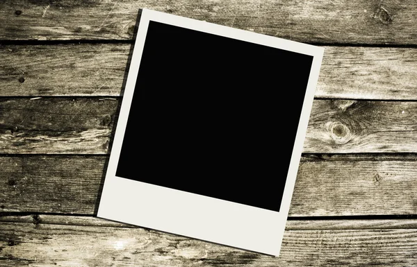 Polaroid over wooden texture — Stock Photo, Image