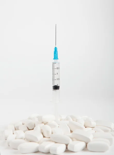 Syringe and a tablets Royalty Free Stock Images