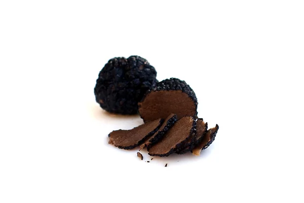 Black truffles isolated on white (shallow depth of field) — Stock Photo, Image