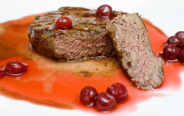 Gourmet food - steak in cherry sauce — Stok fotoğraf