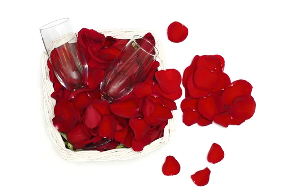 Płatki róż, serce i dwie szklaneczki wina - koncepcja miłości — Zdjęcie stockowe