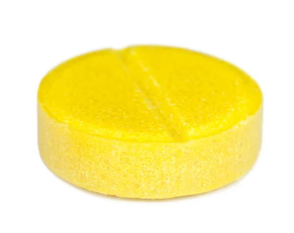 Comprimido médico amarelo no fundo branco — Fotografia de Stock