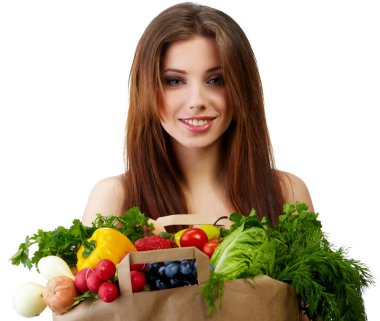 Woman holding a bag full of healthy food. shopping . clipart