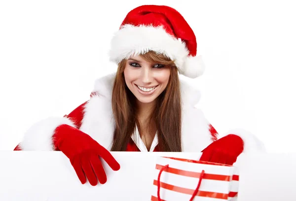 Schöne Weihnachtsfrau mit Weihnachtsmütze und leerem Brett — Stockfoto