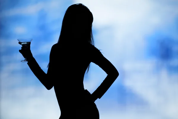 Dancing silhouettes of women with champagne in a nightclub — Stock Photo, Image