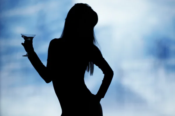Dancing silhouettes of women with champagne in a nightclub — Stock Photo, Image
