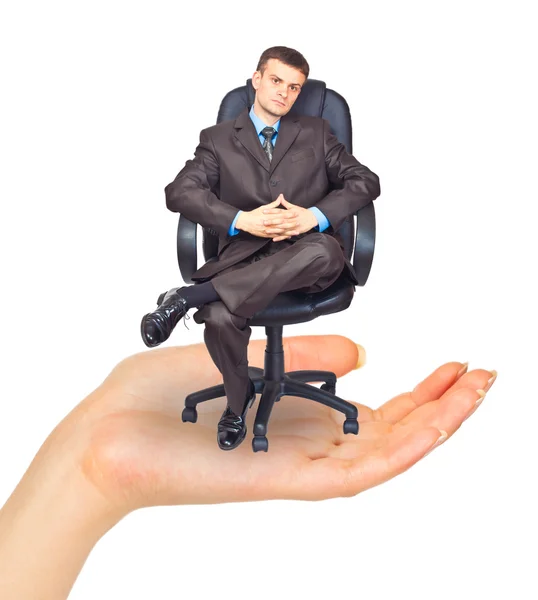 Businessman sitting on chair in hand — Stock Photo, Image