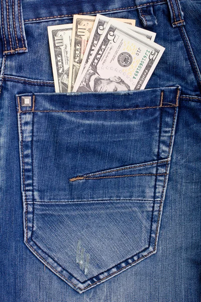蓝色牛仔裤口袋里的美元 — 图库照片