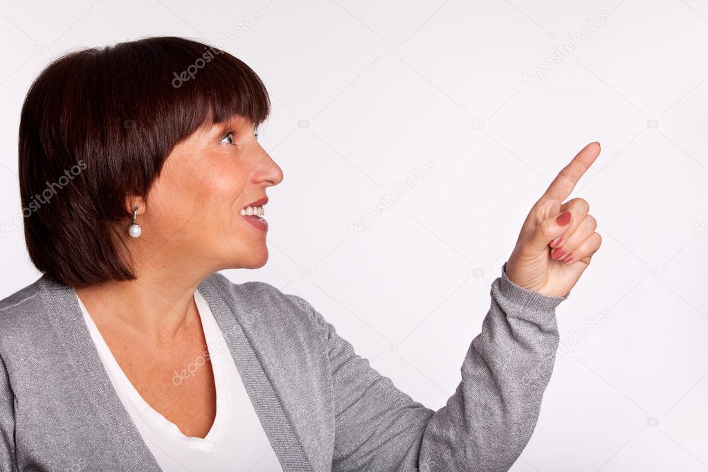 Mid woman showing a finger in the direction