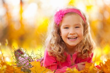 Happy girl in autumn park clipart