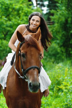 Beautiful woman riding horse clipart