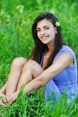 Charming young woman sitting green grass clipart