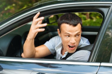 Portrait young man sitting car looking out clipart