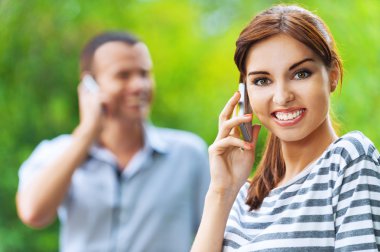 Portrait young beautiful happy couple talking phone clipart