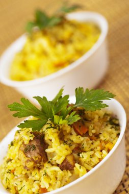 Closeup two portion yummy pilaf (rice,meat,pork,carrot)decorated clipart