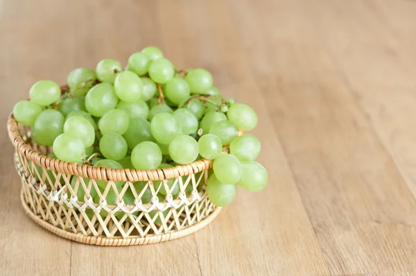Cesta de vime cacho uvas verdes closeup — Fotografia de Stock