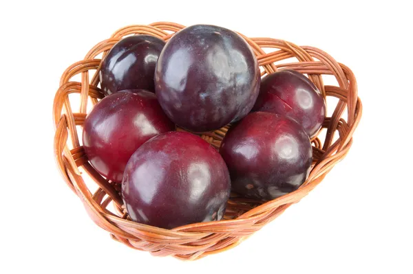 stock image Six plums wicker basket isolated