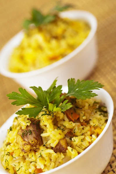 Closeup two portion yummy pilaf (rice,meat,pork,carrot)decorated — Stock Photo, Image