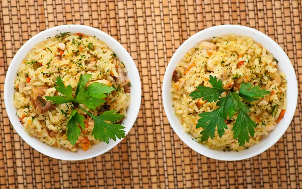 Pilaf (meat, carrots, rice) decorated parsley — Stock Photo, Image