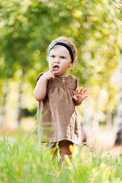 Portrait little cute girl holding finger mouth — Stock Photo, Image