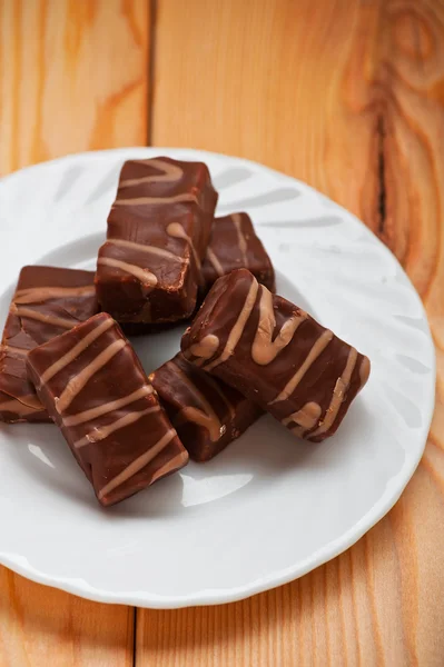 Six chocolates on saucer — Stock Photo, Image