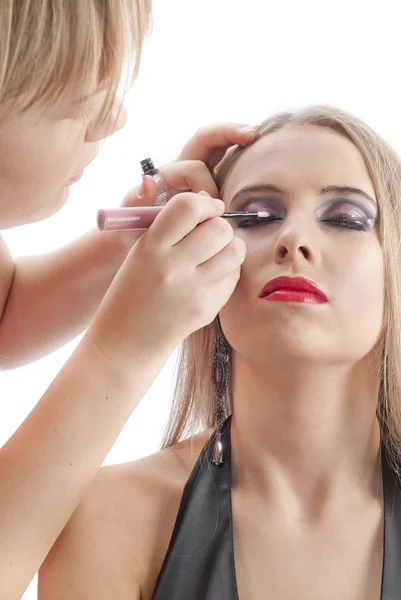 Beautiful young model getting fashion make-up — Stock Photo, Image