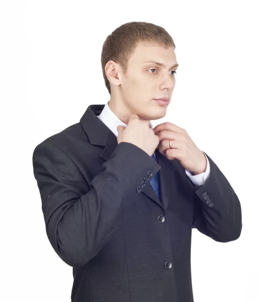 Portrait of a young handsome male, correcting a shirt — Stock Photo, Image