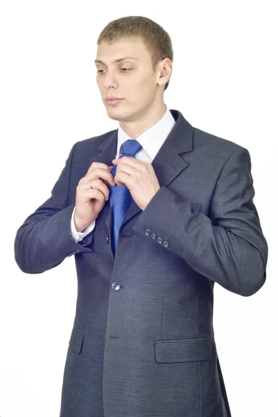 Portrait of a young handsome male, correcting a tie — Stock Photo, Image